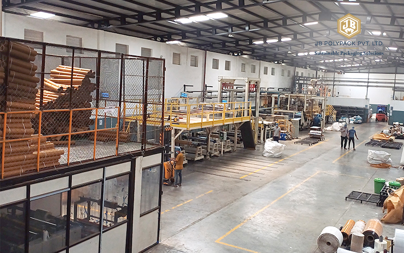 JB Polypack production floor with packaging machinery and material rolls